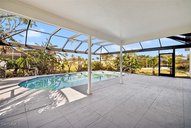 view of pool featuring a lanai and a patio