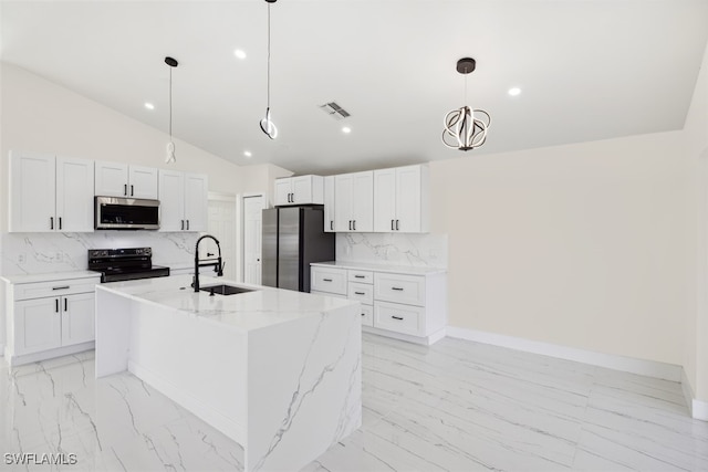 kitchen with decorative backsplash, stainless steel appliances, a kitchen island with sink, white cabinets, and hanging light fixtures