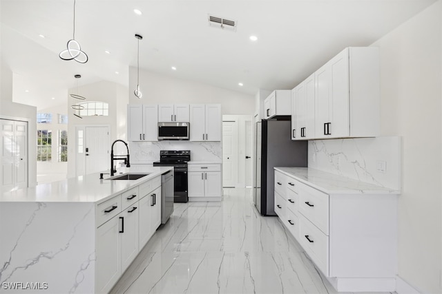 kitchen with hanging light fixtures, sink, appliances with stainless steel finishes, and tasteful backsplash