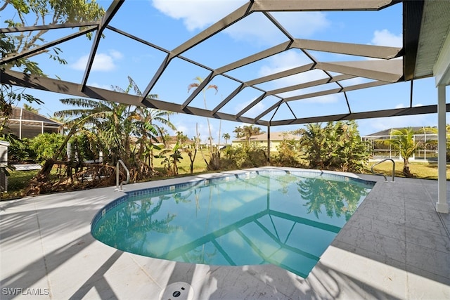 view of pool with a patio area and a lanai