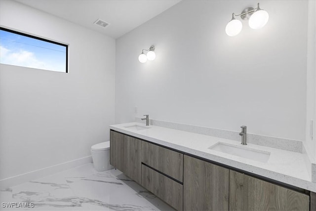 bathroom featuring toilet and vanity