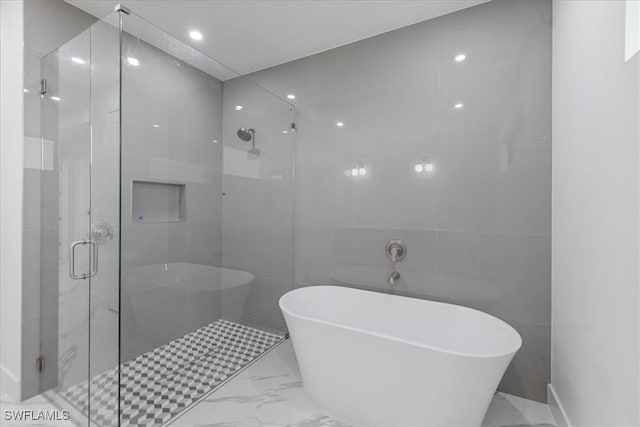 bathroom with shower with separate bathtub