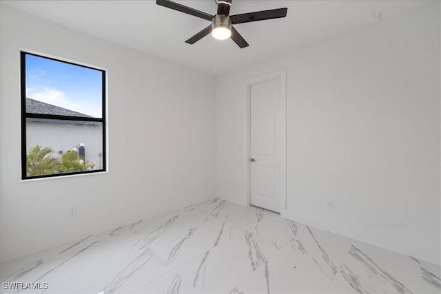 unfurnished room featuring ceiling fan and a wealth of natural light