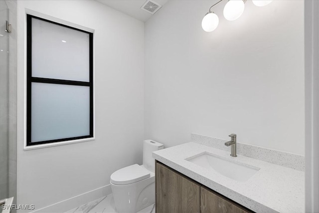 bathroom featuring toilet and vanity