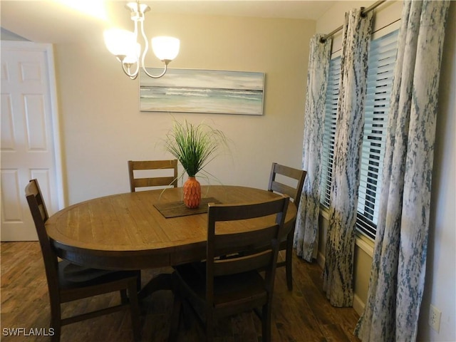 dining room featuring dark hardwood / wood-style floors and an inviting chandelier