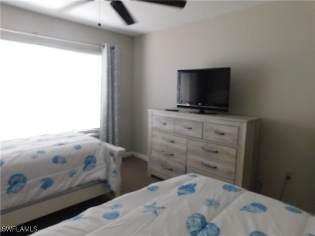 bedroom with ceiling fan and multiple windows