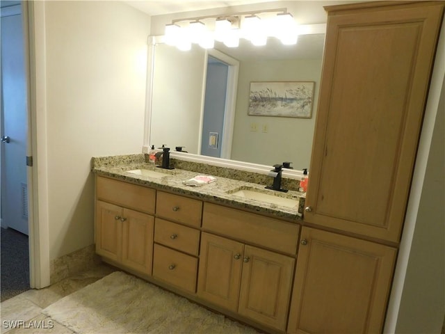 bathroom with tile patterned flooring and vanity