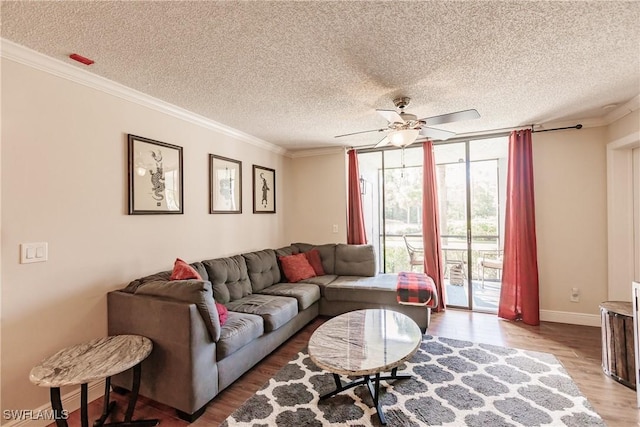 living room featuring floor to ceiling windows, ceiling fan, crown molding, and wood-type flooring