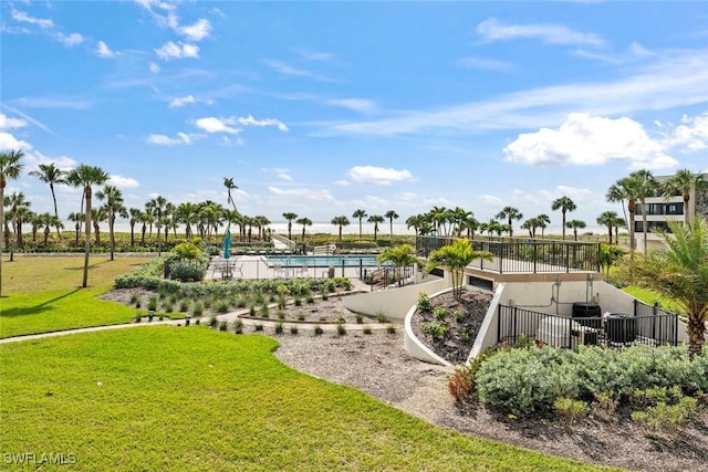 surrounding community featuring a swimming pool and a lawn