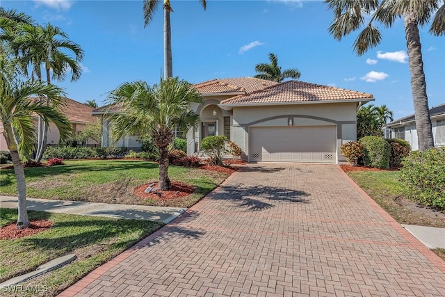 mediterranean / spanish-style house with a front lawn and a garage