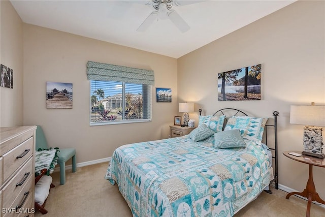 bedroom featuring ceiling fan and light carpet