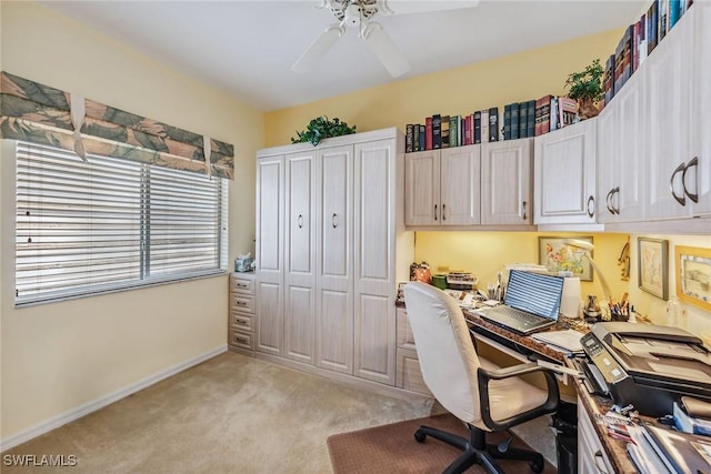 office space with ceiling fan and light carpet