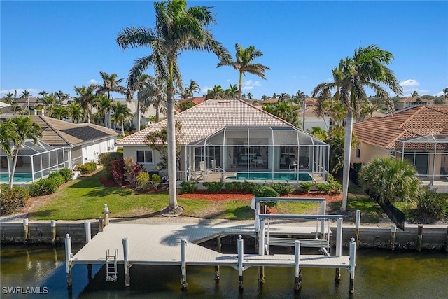 dock area with a lanai, a lawn, and a water view