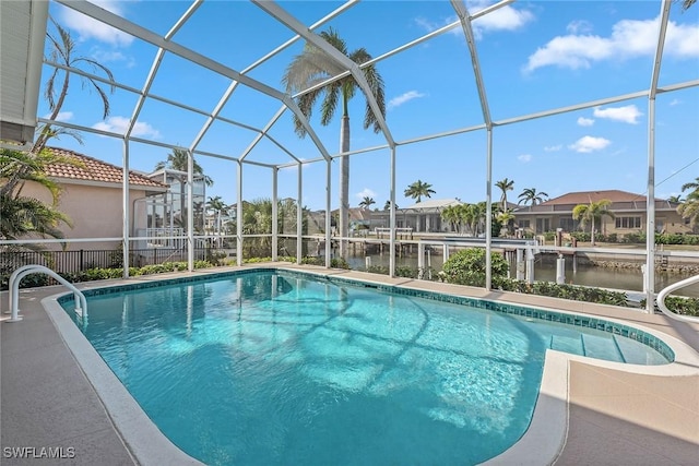 view of pool featuring a lanai and a water view