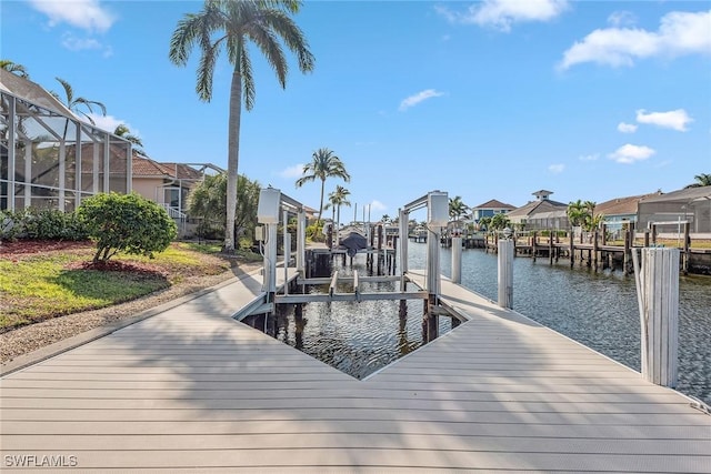 dock area featuring glass enclosure and a water view