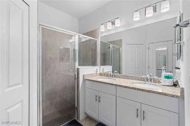 bathroom featuring vanity, tile patterned floors, and walk in shower