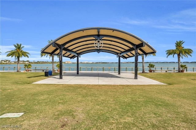 view of home's community with a water view and a yard