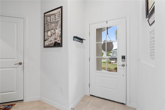 entryway with light tile patterned floors and plenty of natural light