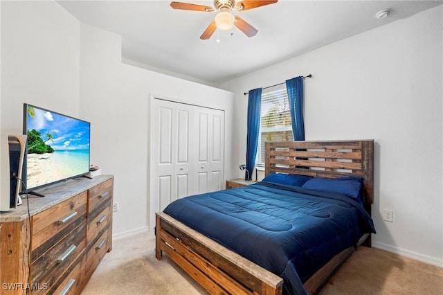 carpeted bedroom featuring ceiling fan and a closet