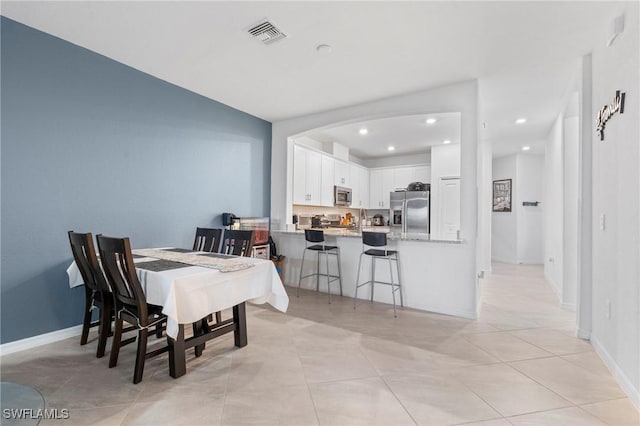 dining space featuring light tile patterned floors