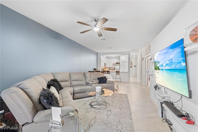 tiled living room with ceiling fan