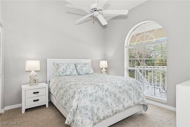 bedroom featuring ceiling fan and light carpet