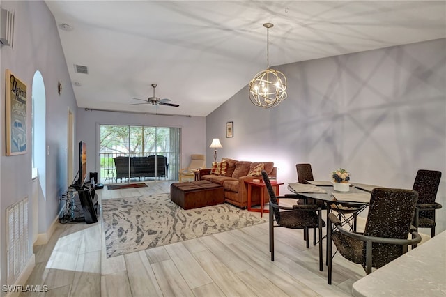 dining area with lofted ceiling and ceiling fan with notable chandelier