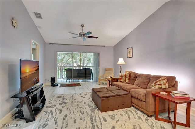 living room featuring light hardwood / wood-style floors, ceiling fan, and vaulted ceiling