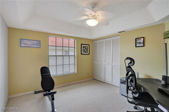 office area with ceiling fan, a textured ceiling, and a raised ceiling