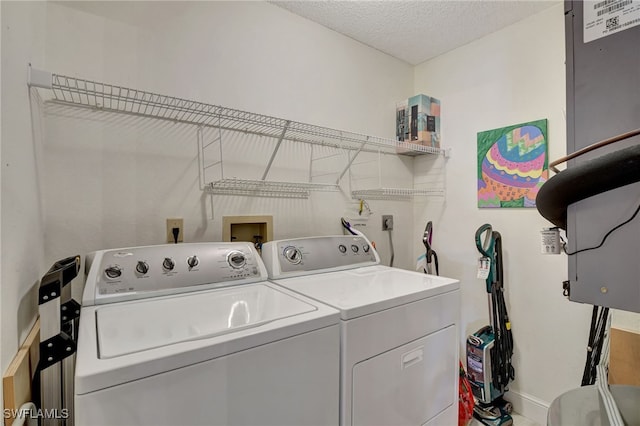 laundry area featuring a textured ceiling and separate washer and dryer