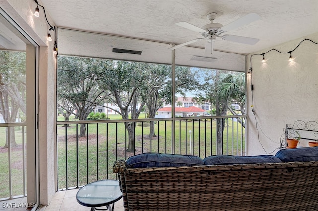 sunroom with ceiling fan and a healthy amount of sunlight