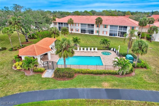 view of swimming pool featuring a lawn