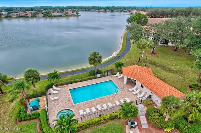 view of swimming pool with a water view and a patio