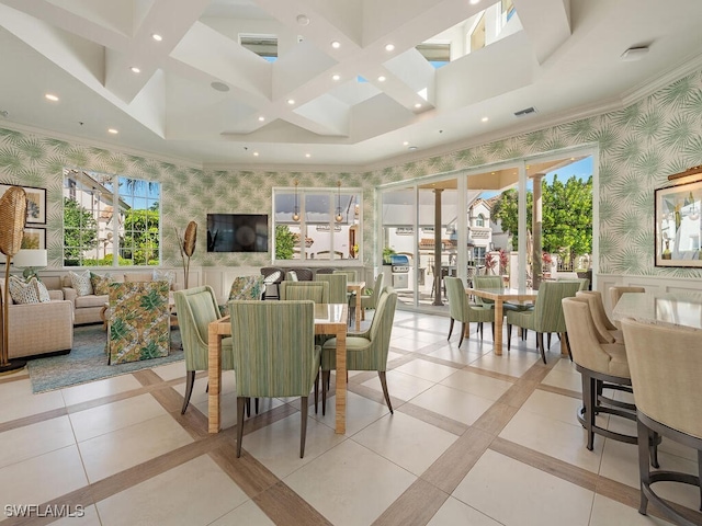 tiled dining area with a healthy amount of sunlight and ornamental molding