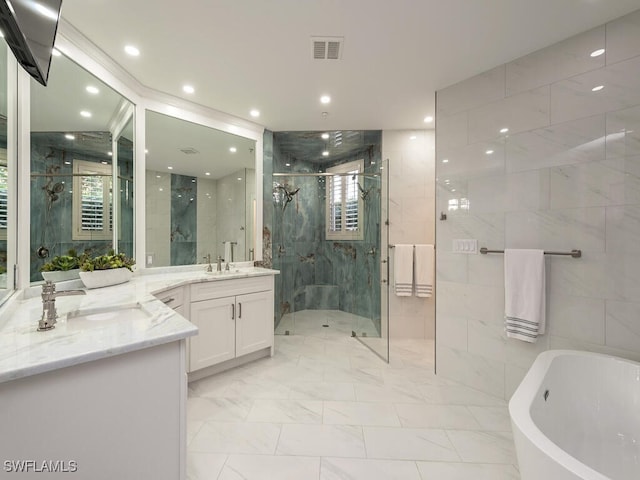 bathroom featuring vanity, plus walk in shower, and tile walls