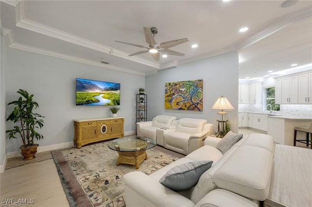 living room with light wood-type flooring, ceiling fan, and crown molding