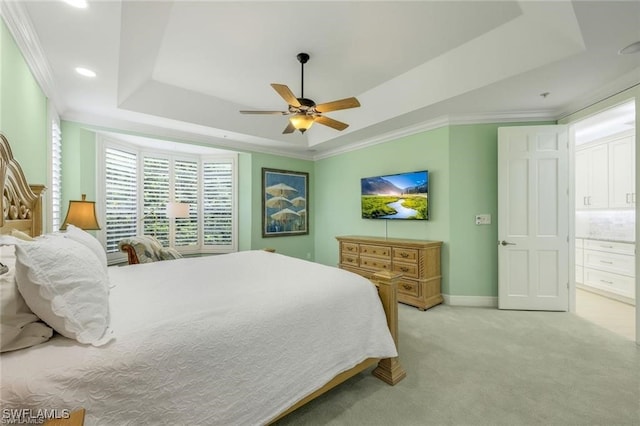 carpeted bedroom featuring a raised ceiling, ceiling fan, and crown molding