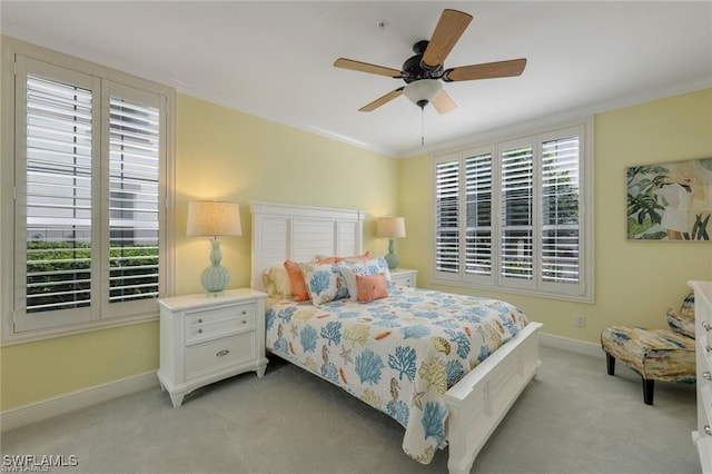 bedroom featuring ceiling fan, crown molding, and light colored carpet