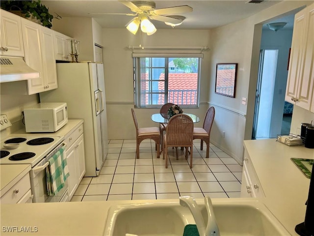 kitchen with light tile patterned floors, white appliances, white cabinetry, and ceiling fan