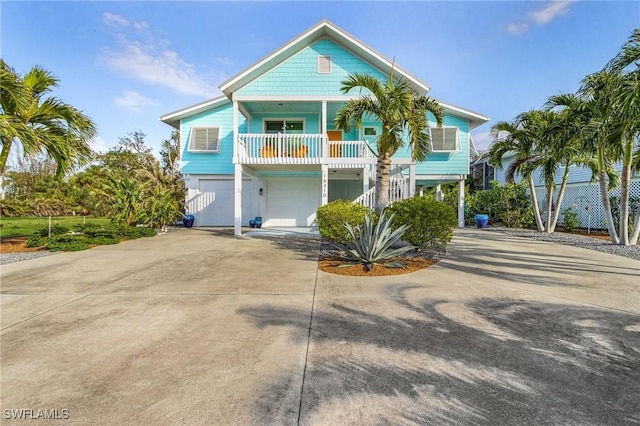 coastal home with a porch and a garage