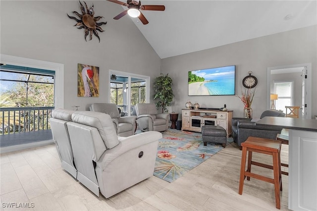 living room featuring high vaulted ceiling, ceiling fan, and a healthy amount of sunlight