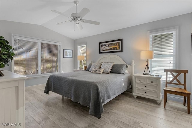 bedroom with multiple windows, ceiling fan, vaulted ceiling, and light hardwood / wood-style flooring