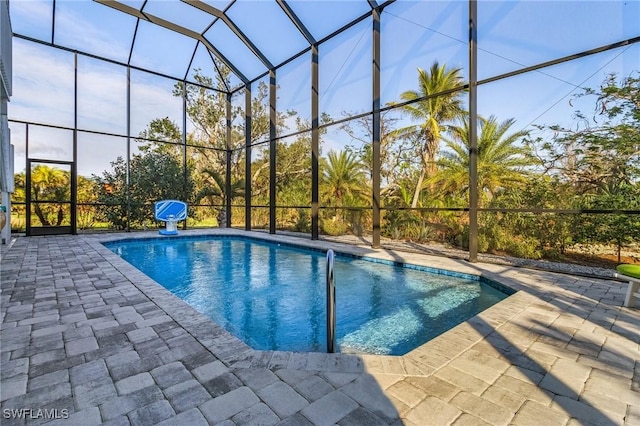 view of swimming pool with a lanai and a patio