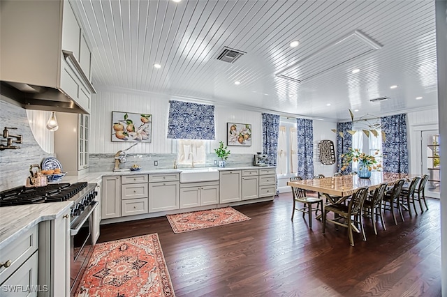 dining room featuring ornamental molding, sink, and dark hardwood / wood-style floors