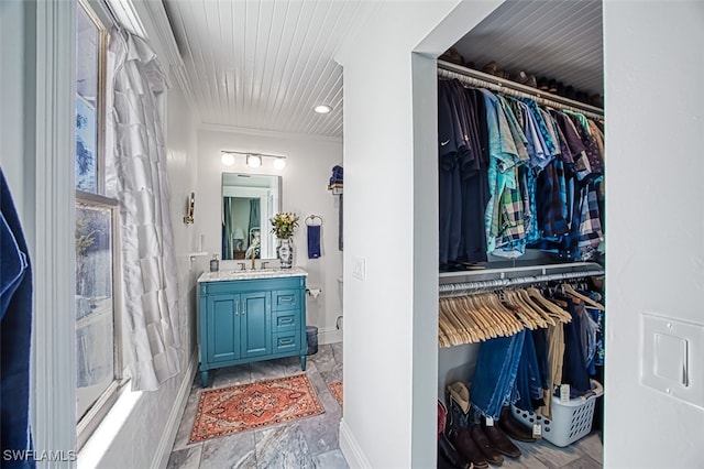 bathroom with ornamental molding and vanity