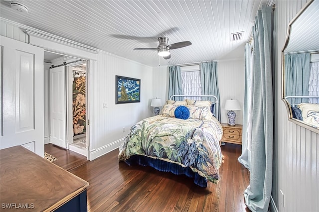 bedroom with crown molding, ceiling fan, and dark hardwood / wood-style flooring