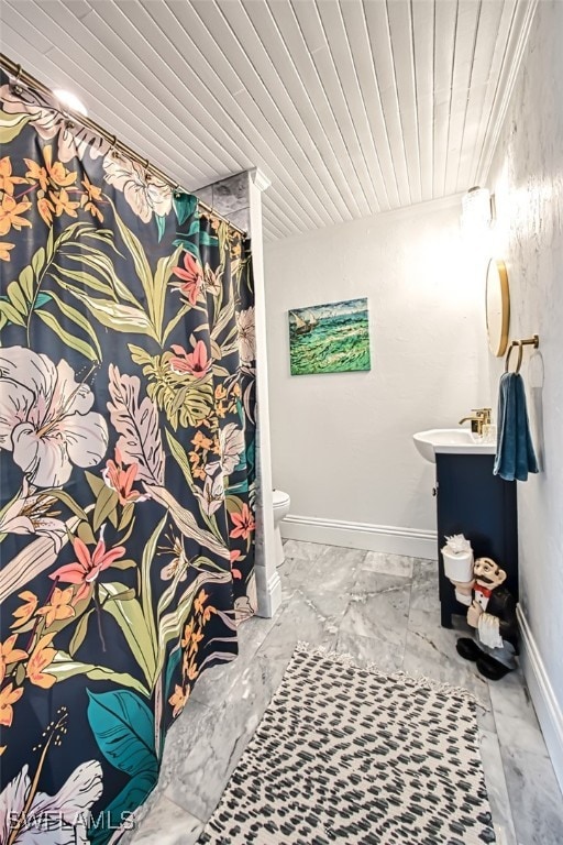 bathroom featuring vanity, wood ceiling, and toilet