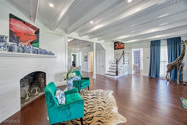 living room featuring a brick fireplace, dark wood-type flooring, and beam ceiling