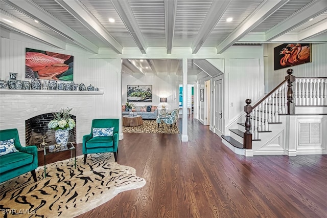 interior space featuring hardwood / wood-style floors, a fireplace, and beamed ceiling