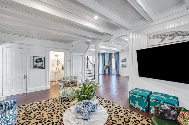 living room with beam ceiling and dark wood-type flooring